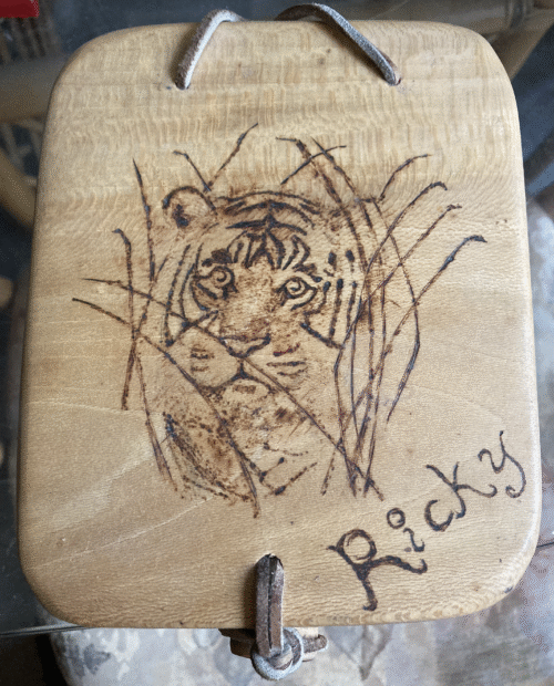 A Sycamore box with an image of a tiger burned in the lid.