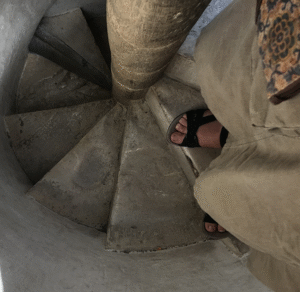 My feet going down a small spiral staircase.